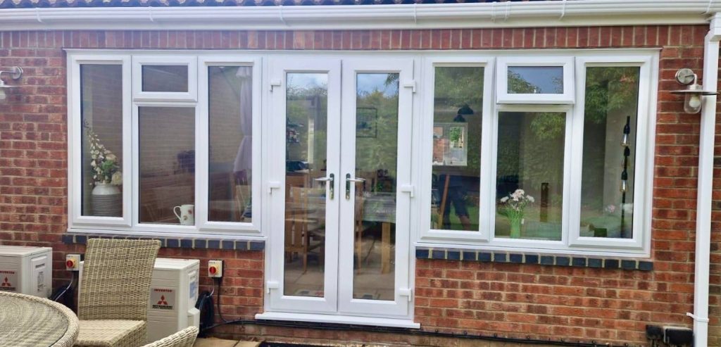 White uPVC French Door and side windows installed on a house in Bourne