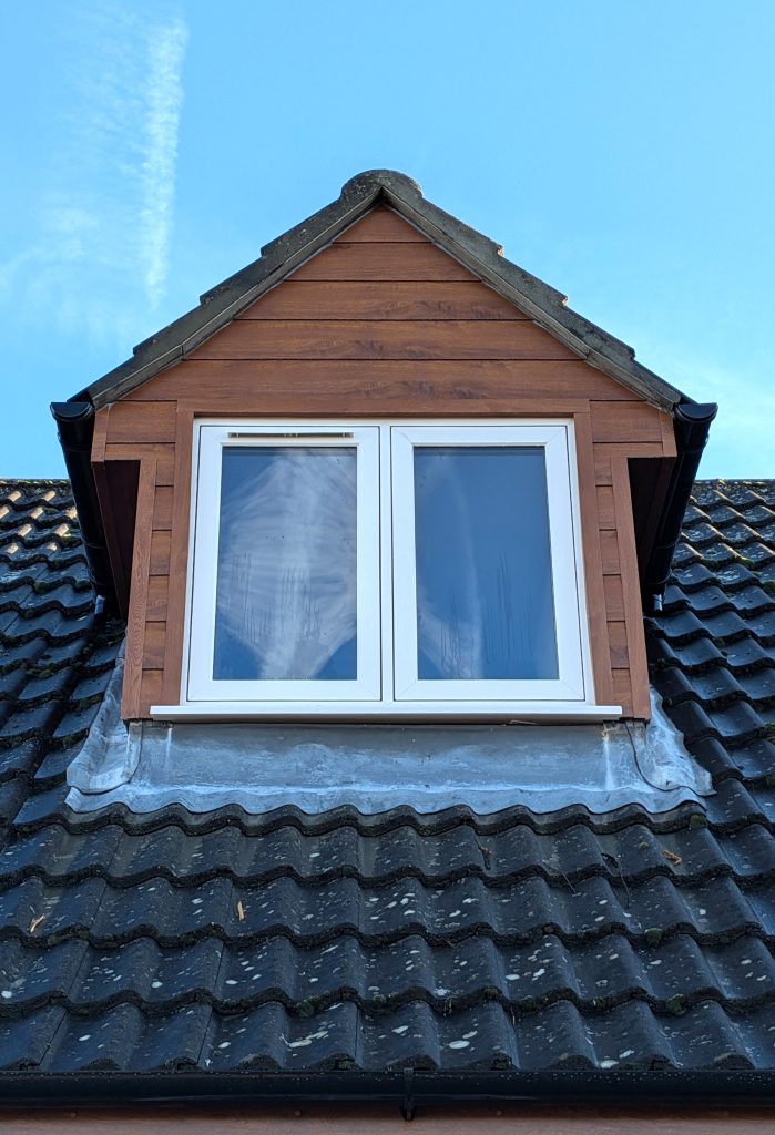 Golden Oak Cladding, Dormer and Cream Window installed on a home in Kirton, Lincolnshire